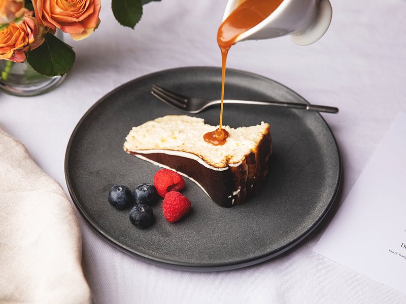 Adding the finishing touches to a slice of cheesecake