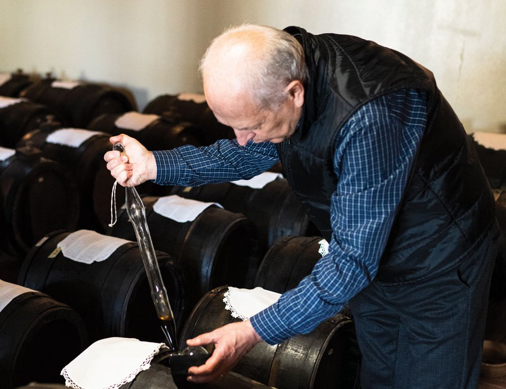 Alberto Ferrari testing a batch of balsamic vinegar