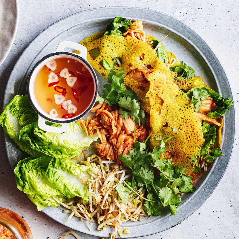 Crispy turmeric pancakes with kimchi, chilli dipping sauce and sprouts