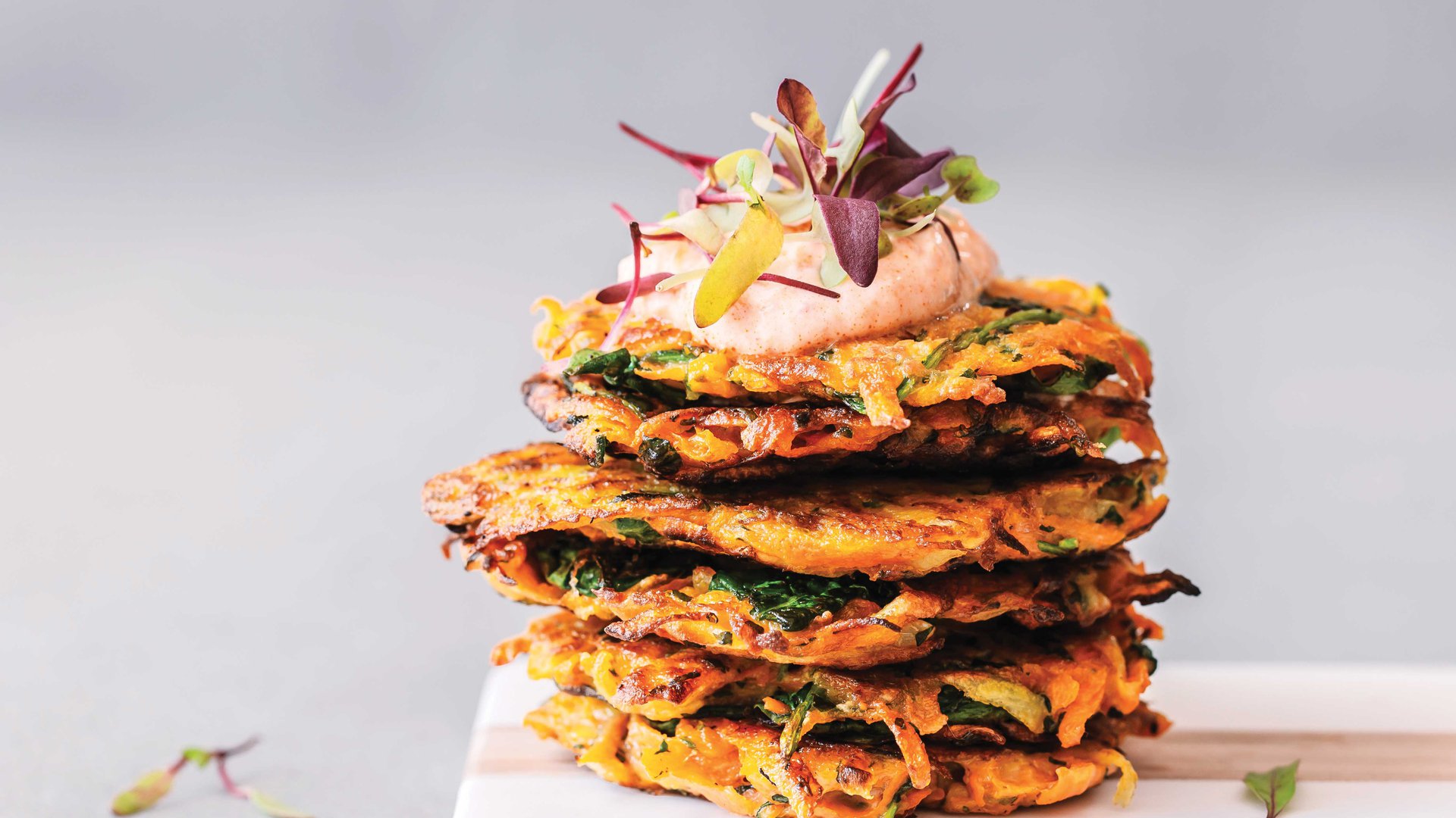 Sweet potato and carrot fritters with harissa yoghurt