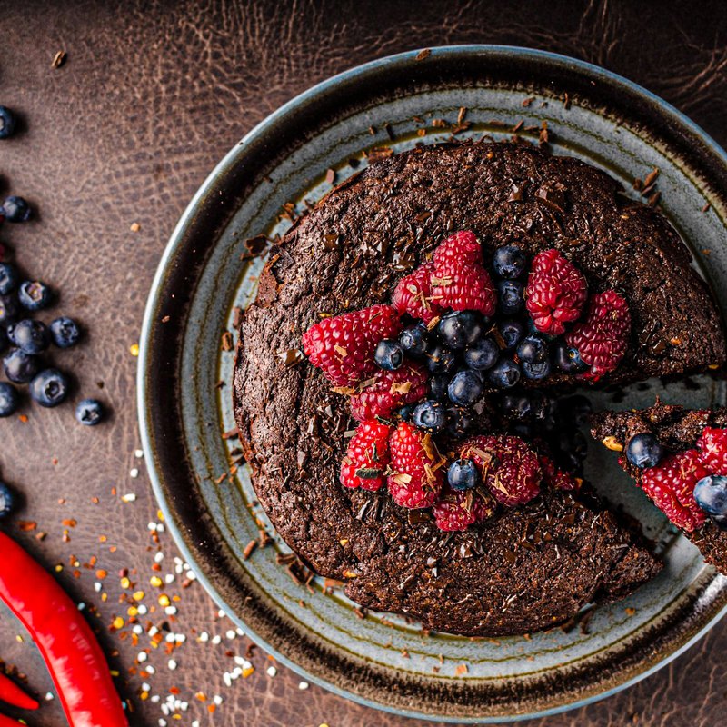Chocolate brownie cake with chili and fresh berries