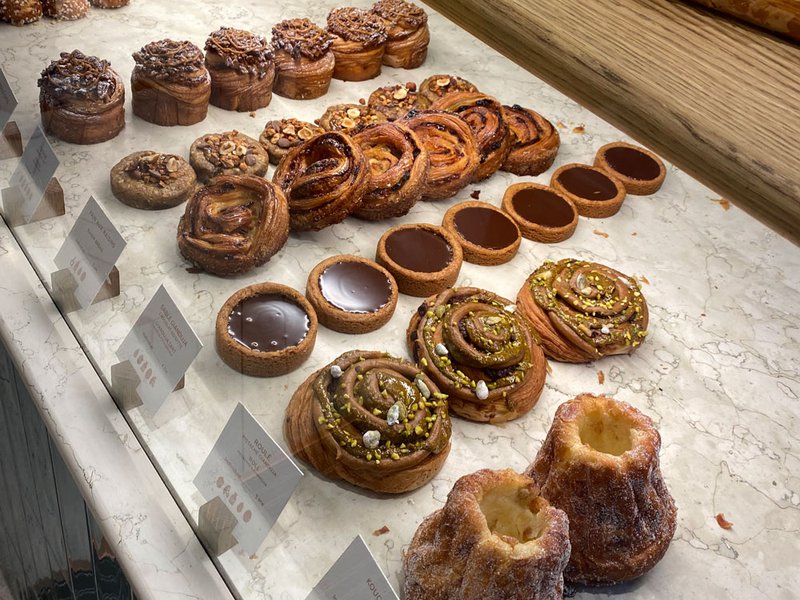 Freshly baked pastries displayed at Yann Couvreur | Our first morning in Paris |Whipping cream | Filling the tarte ISATIS