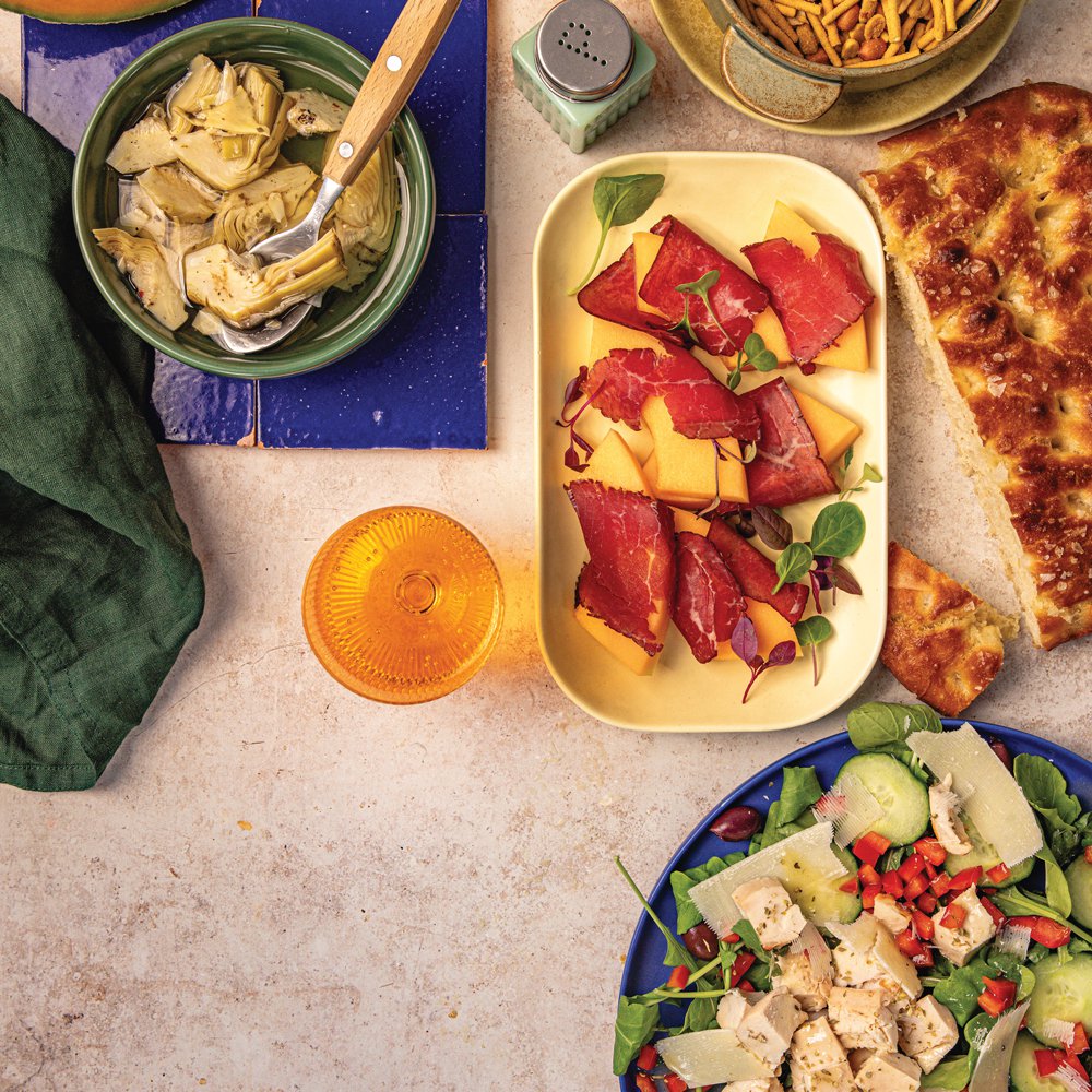 Italian chicken salad with focaccia and bresaola wrapped rock melon