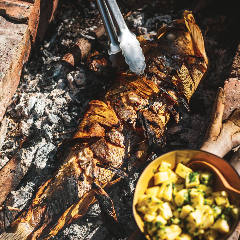 Mexican barbecued whole fish in corn husks