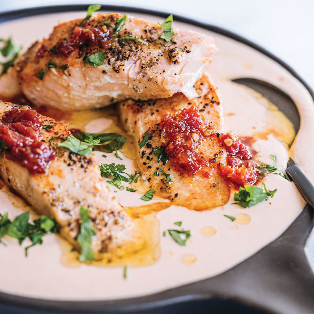 Pan-fried salmon in creamy sundried tomato sauce