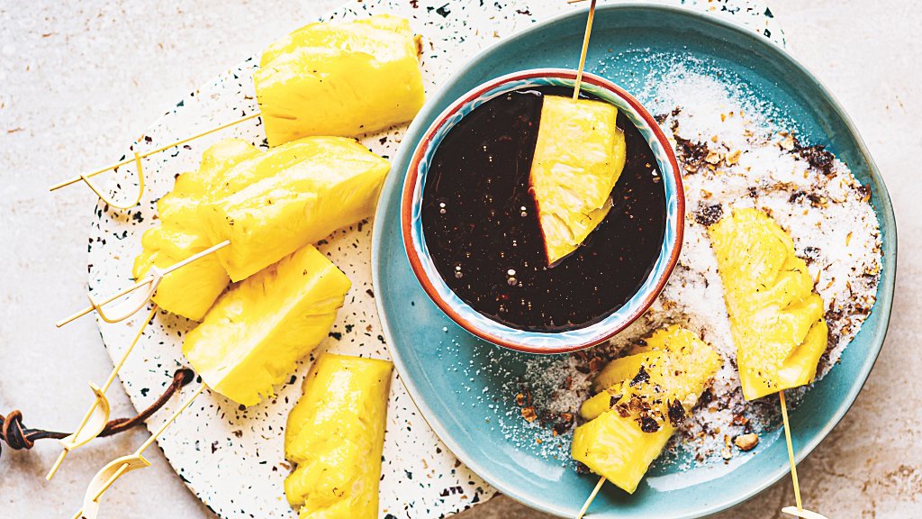 Pineapple skewers with date syrup fondue and loumi sugar