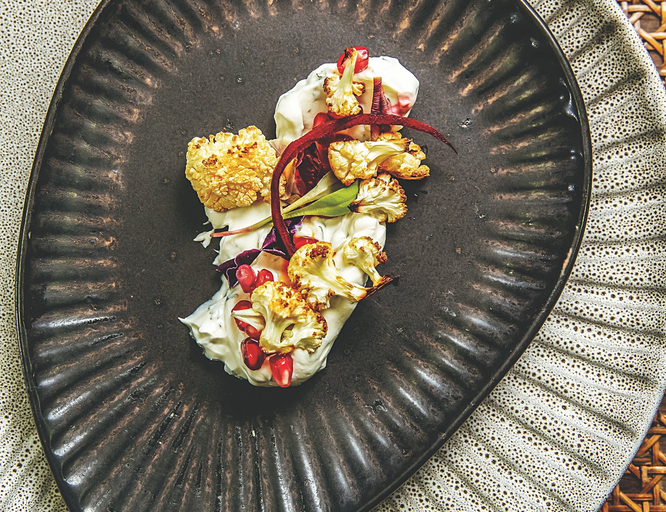 Roasted cauliflower florets on a herb and labneh base