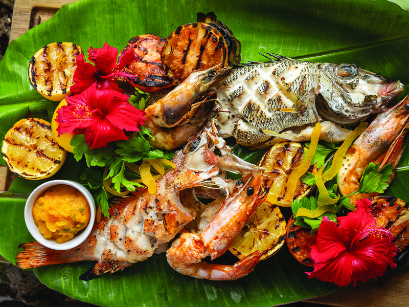 A Creole cooking class teaches guests to make a traditional garden curry and fish steaks  │ The waters of Petite Anse Bay offer excellent swimming and snorkelling  │ Grilled seafood platter at Kannel restaurant