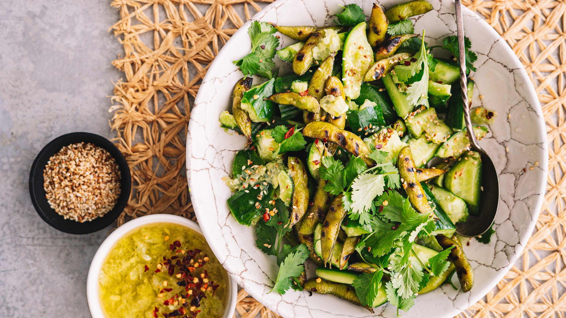 Smashed cucumber salad with grilled edamame beans and cucumber seed