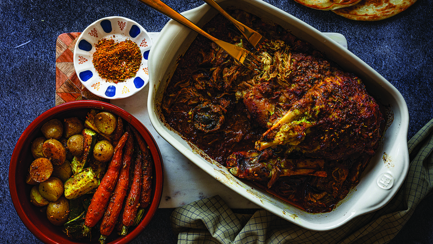 Pulled Welsh lamb shoulder with roasted b’zar-spiced vegetables