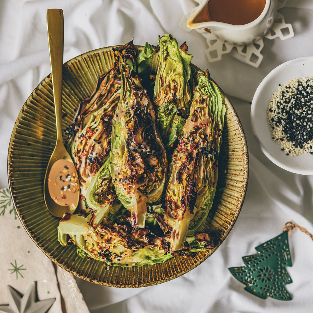 Charred pointed cabbage wedges in tahini sauce with hot honey
