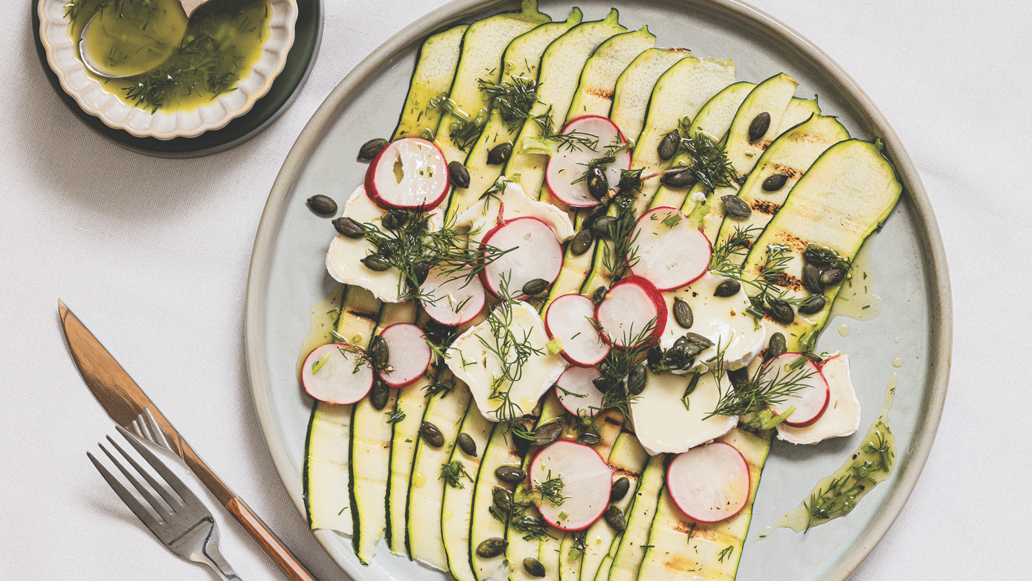Grilled courgette ribbons with pickled radish, goat’s cheese and dill