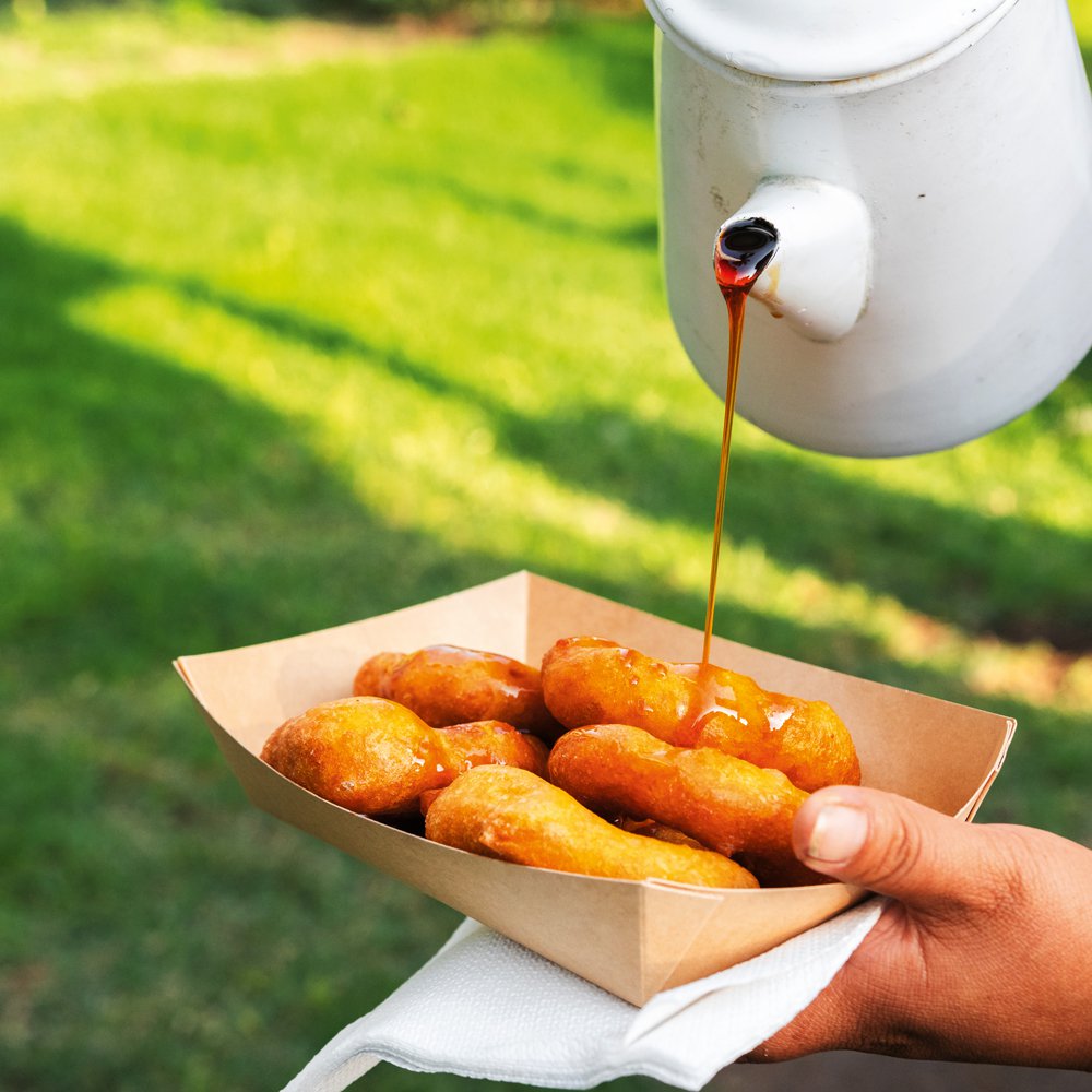 Piping-hot picarones drizzled in syrup at Picarones Mary