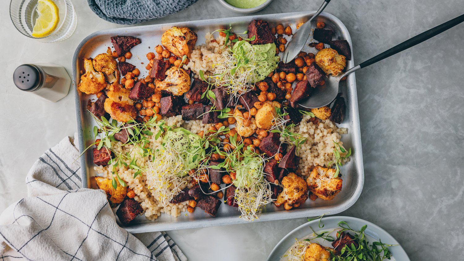 Roasted cauliflower, purple sweet potato and chickpea bowl with herby cashew cream