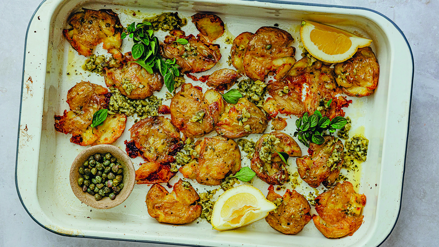 بطاطا صغيرة مشوية ومهروسة مع صلصة الزبدة بالزيتون الأخضر والكبر