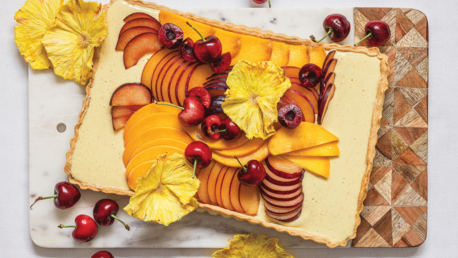 Stonefruit shrikhand tart with pineapple blossoms