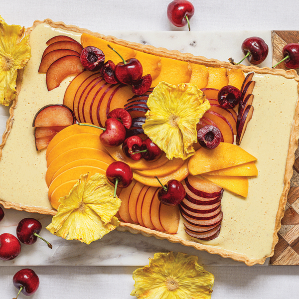 Stonefruit shrikhand tart with pineapple blossoms