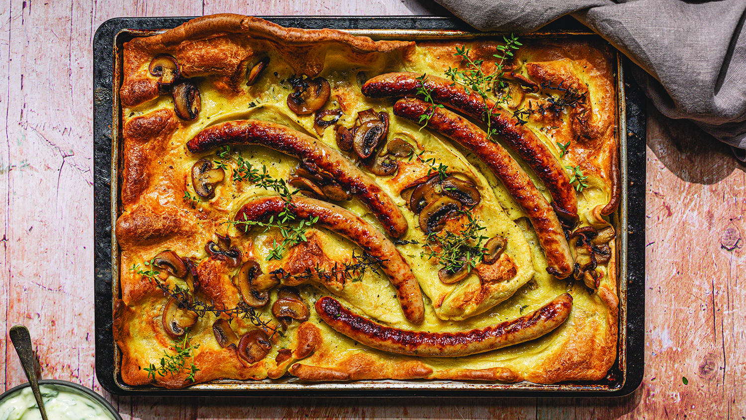 Tandoori chicken sausage and mushroom toad-in-the-hole with raita
