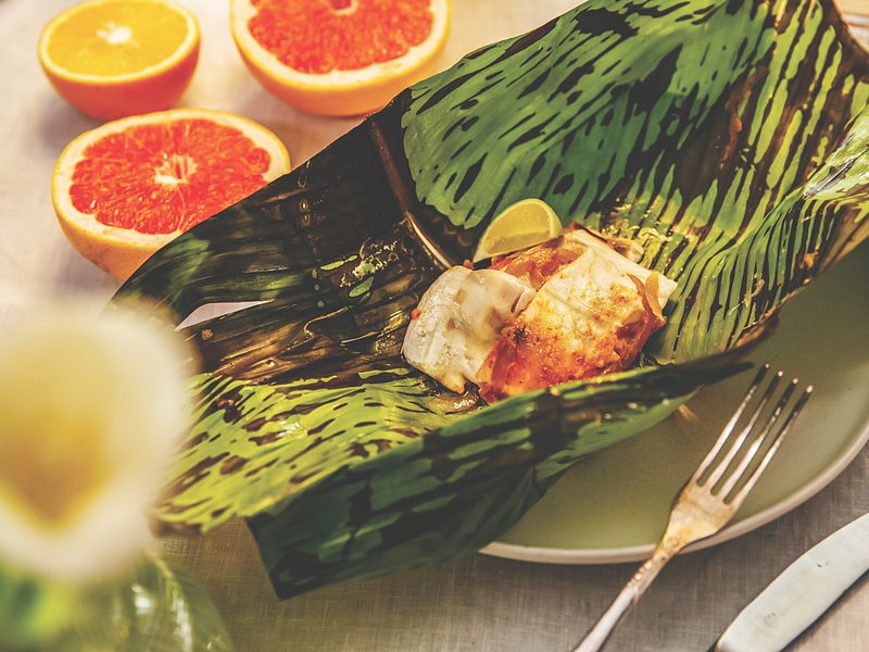 Tender sea bass inside a banana leaf parcel