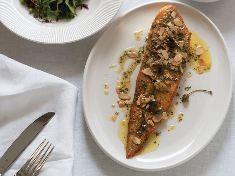 The sole meunière has been inspired by Natasha’s trips to Paris | The book is filled with original art | The saganaki prawns gets it name from the pan in which it’s prepared