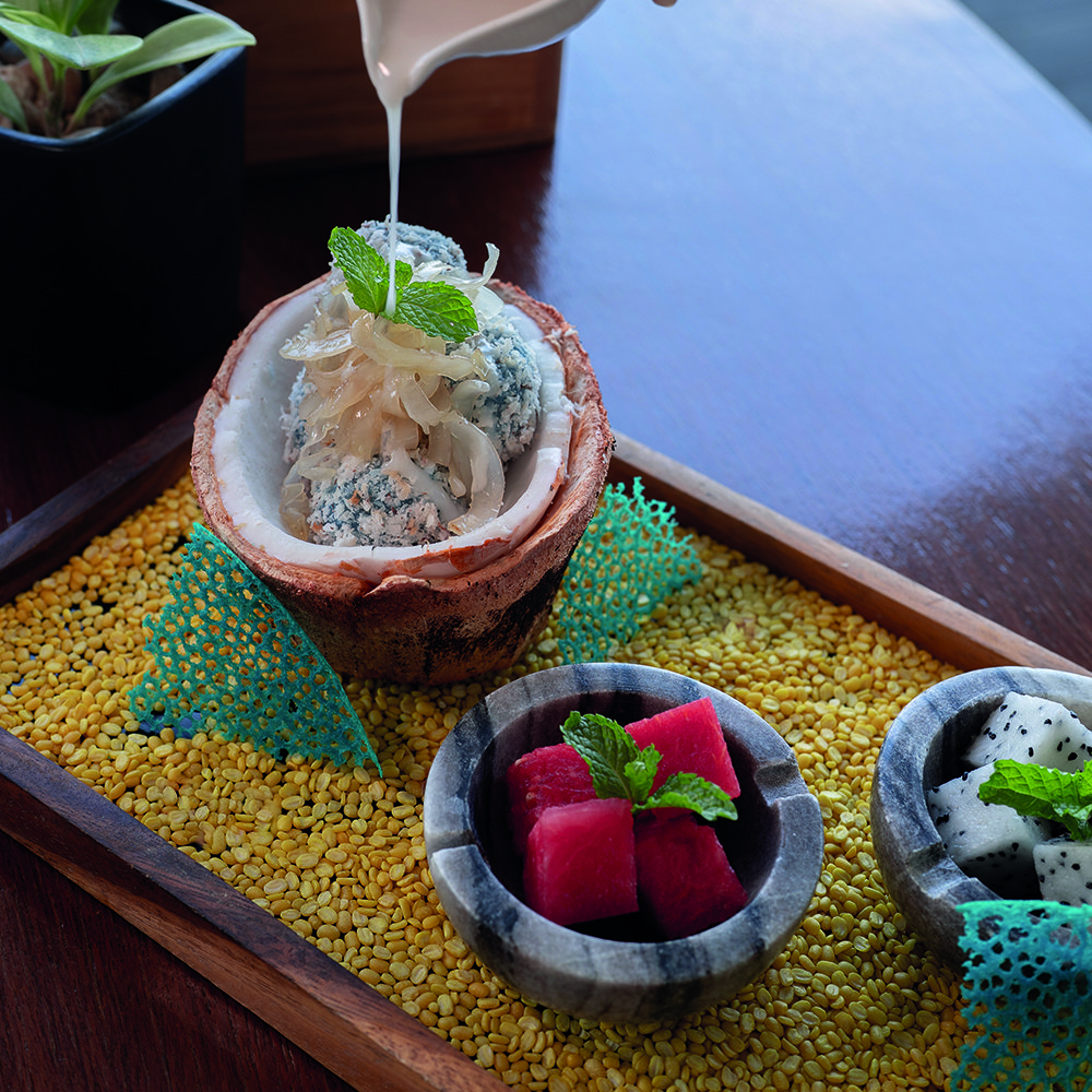 Sweet coconut dumplings served inside a tender coconut