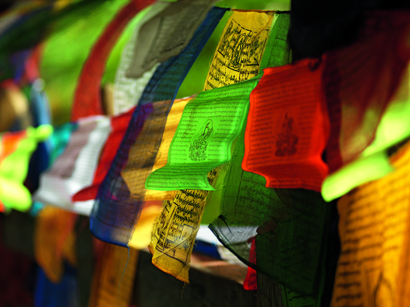 Tiger’s Nest clings precariously to the side of a steep cliff | Prayer flags are a common sight throughout the country | One of COMO Hotel’s most experienced guides, Tshering | 300-year-old Punakha Dzong fortress