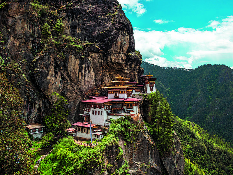 Tiger’s Nest clings precariously to the side of a steep cliff | Prayer flags are a common sight throughout the country | One of COMO Hotel’s most experienced guides, Tshering | 300-year-old Punakha Dzong fortress