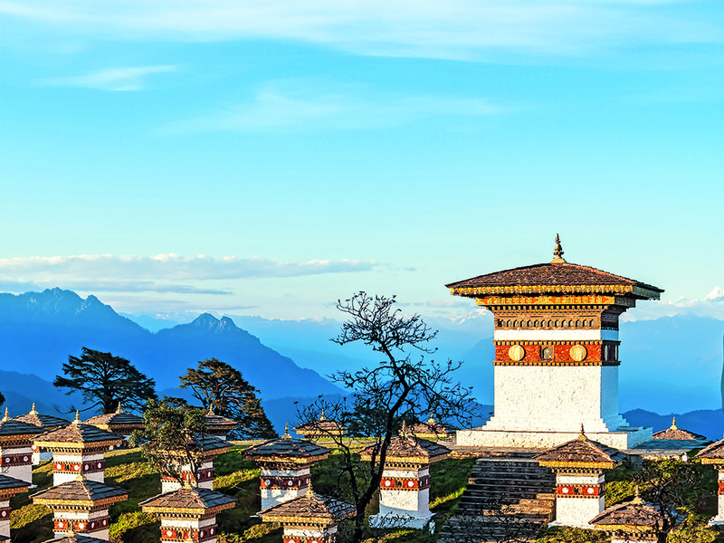 Ornate door at the fortress | A meal at Bukhari, COMO Uma Paro’s restaurant comes with  splendid views | Amid the 108 chortens at Dochula Pass | The sprawling terrace at COMO Uma Punakha