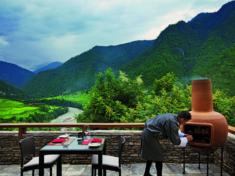 Ornate door at the fortress | A meal at Bukhari, COMO Uma Paro’s restaurant comes with  splendid views | Amid the 108 chortens at Dochula Pass | The sprawling terrace at COMO Uma Punakha