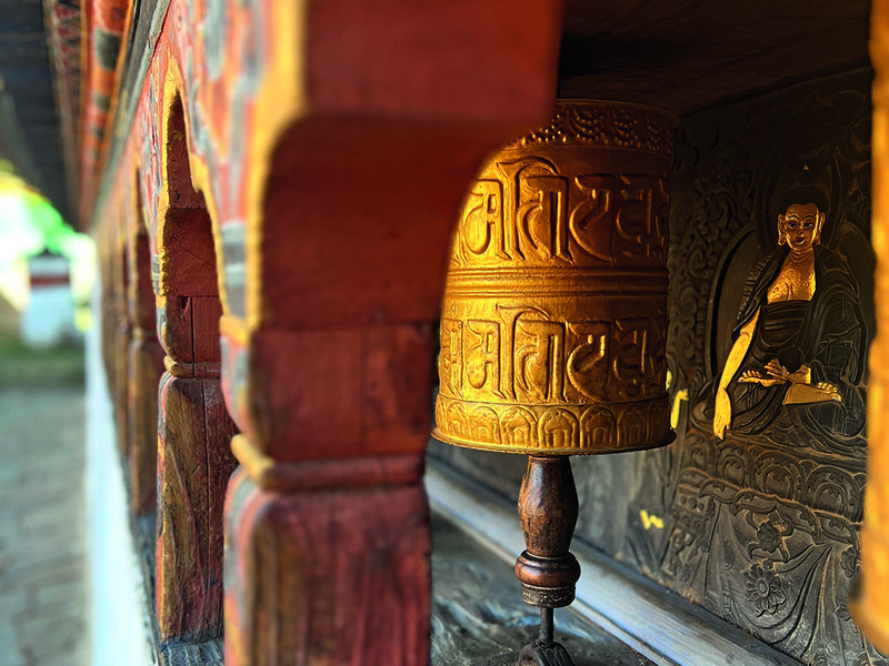 Harvested rice shaped like a stupa | One of the prayer wheels at the fertility temple | Chillies laze in the  sun – they’re dried on rooftops