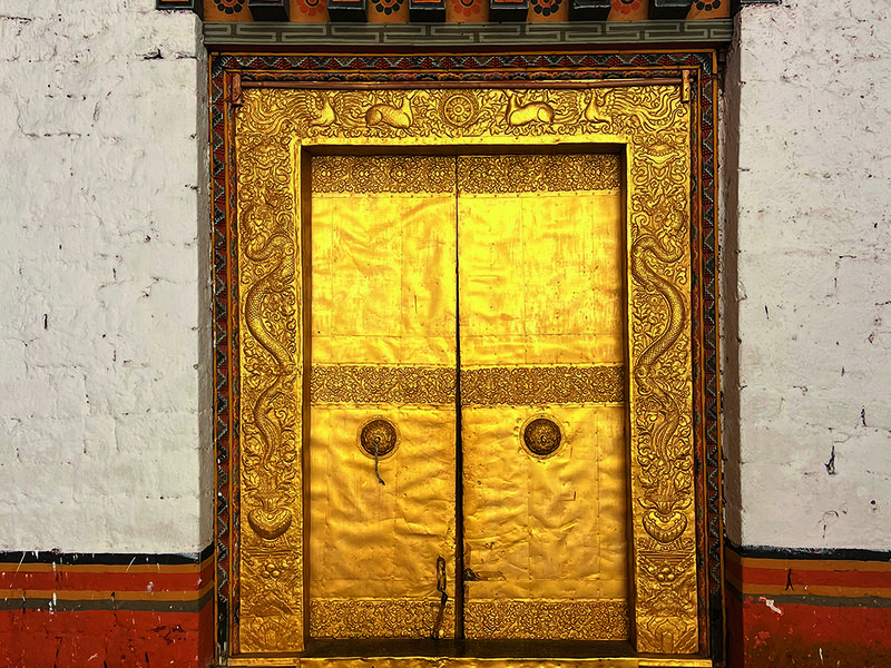 Ornate door at the fortress | A meal at Bukhari, COMO Uma Paro’s restaurant comes with  splendid views | Amid the 108 chortens at Dochula Pass | The sprawling terrace at COMO Uma Punakha
