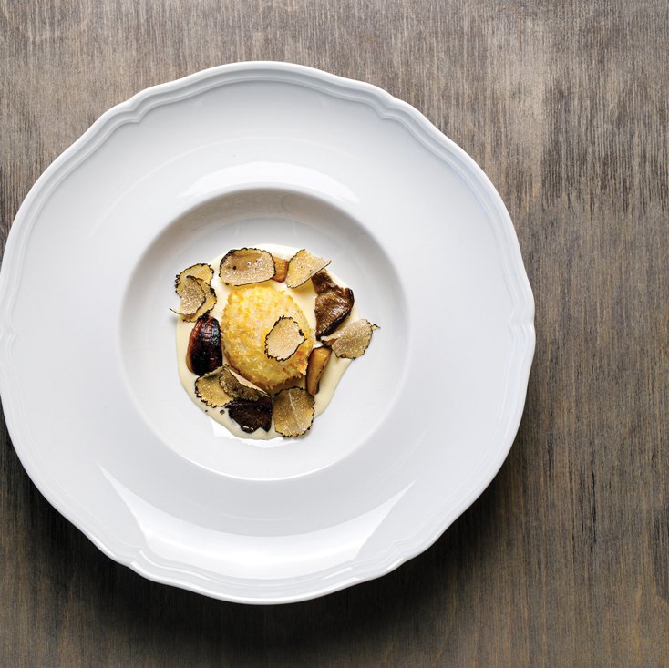 Crispy poached egg on Pecorino cream with mushrooms and truffles