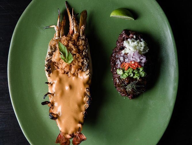 A section of Thai homestyle dishes at Baan, including the spicy, five-spiced egg soup | Giant butterflied lake prawn served at Le Du | Chef Ton and his brother Tam – two of Bangkok’s most hospitable chefs