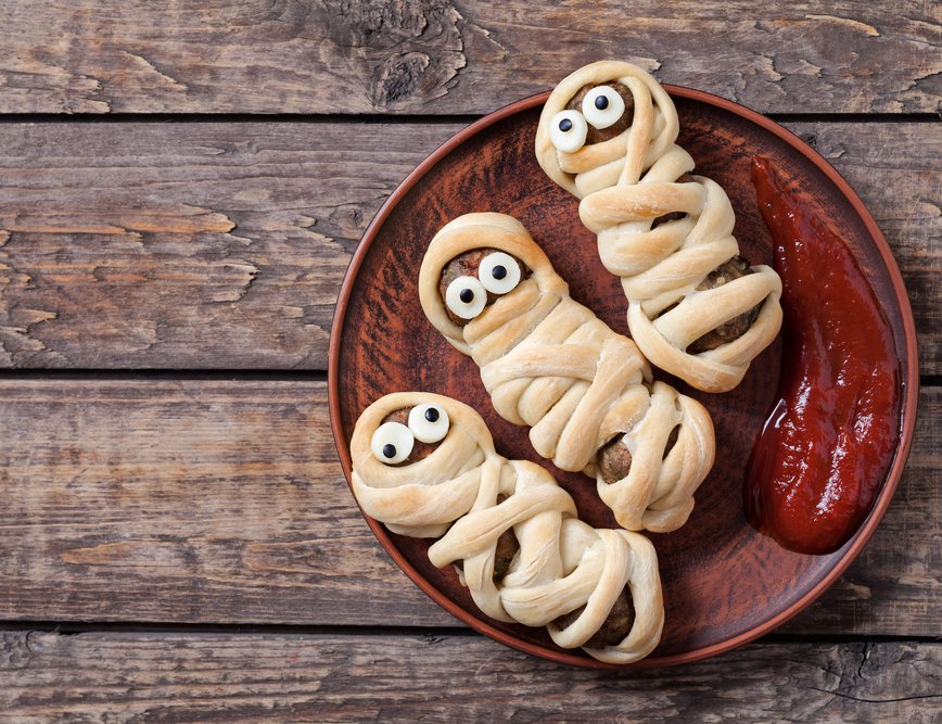Mummified turkey sausage rolls with white bread and black olive eyes